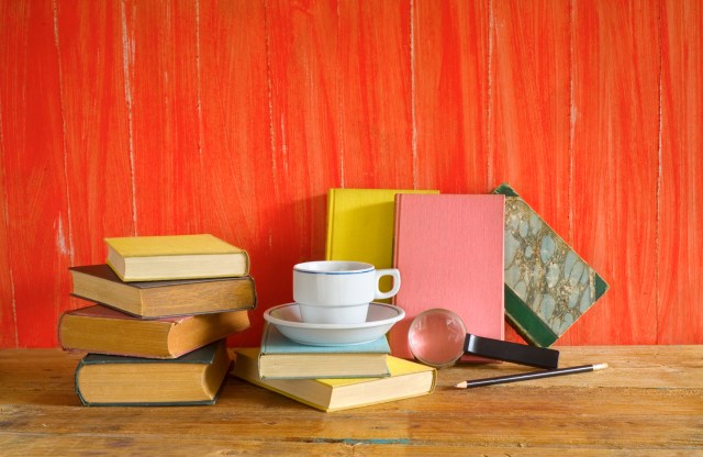 vintage books with cup of coffee,magnifying glass, free copy space